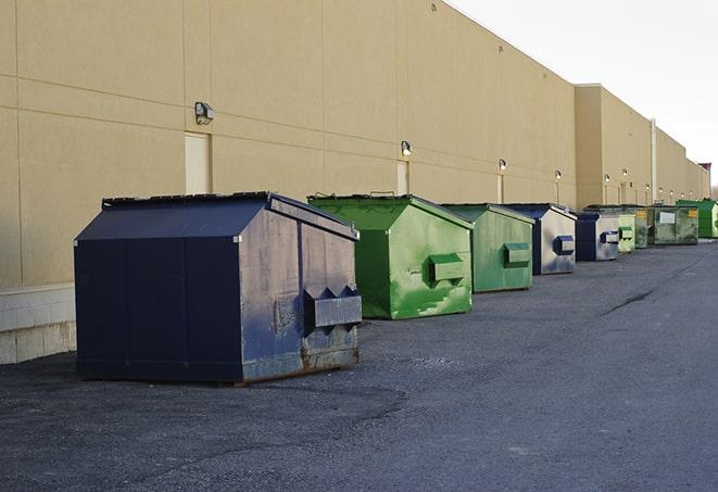 a row of blue construction dumpsters on a job site in Angelus Oaks CA